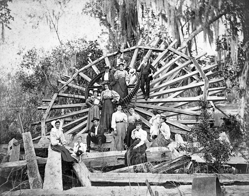 Visitors to DeLeon Springs in 1890 pose by the ruins of the Old Spanish Sugar Mill's waterwheel.