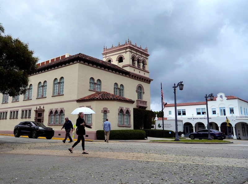 Pedestrians cross South County Road and Chilean Avenue ahead of a cold front near town hall on Feb. 5.