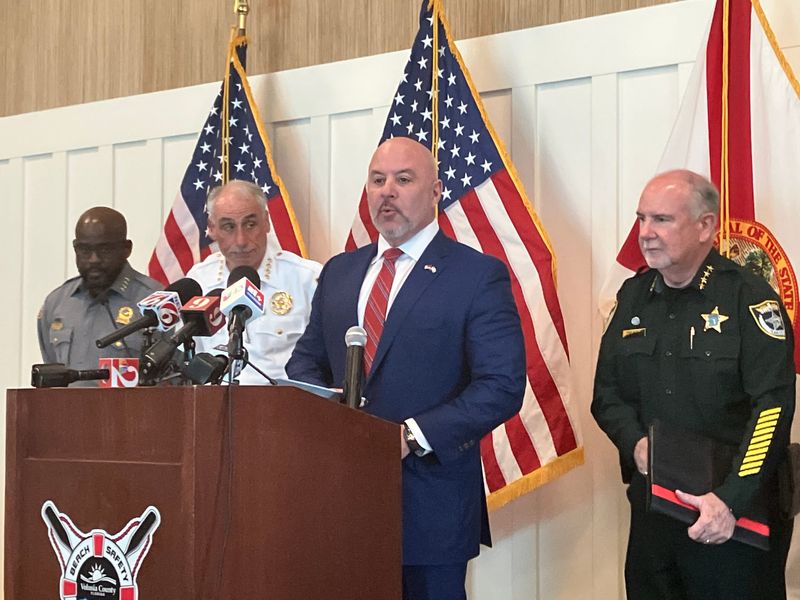Florida Chief Financial Officer Blaise Ingoglia speaks at Volusia County Beach Safety headquarters on Feb. 11, 2026. Daytona Beach Police Chief Jakari Young, far left, Volusia Sheriff Mike Chitwood, left, and Flagler Sheriff Rick Staly, right, stand near him.