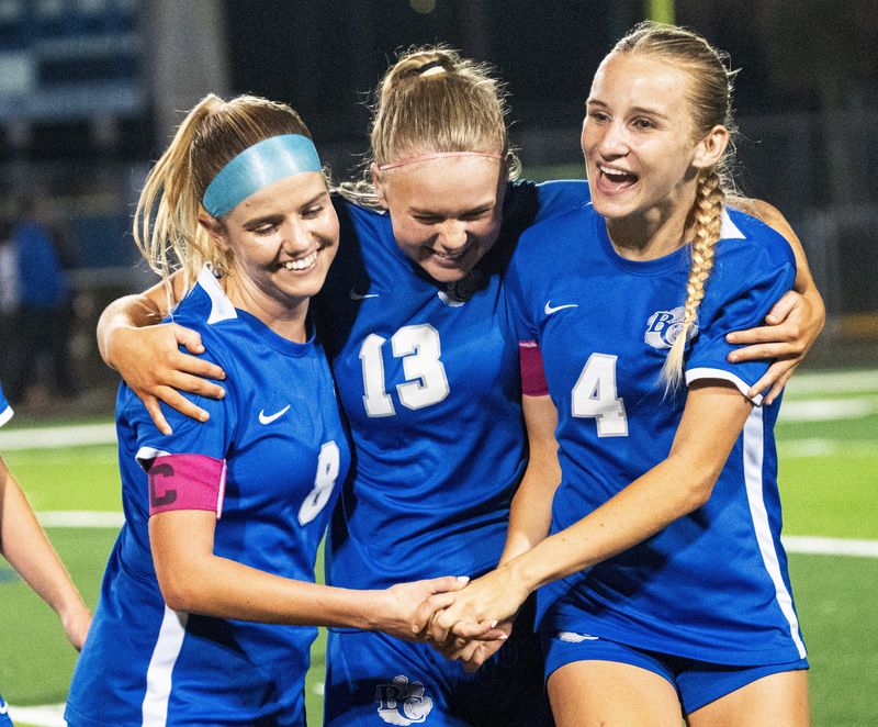 From left, Kaden Crowley, #8, Fiona Peterson, #13, and Eva Rothman #4 of the Barron Collier girls soccer team celebrate a 1-0 win over Naples High School during the Class 4A-Region 3 semifinal at Barron Collier in Naples on Wednesday, Feb. 11, 2026.