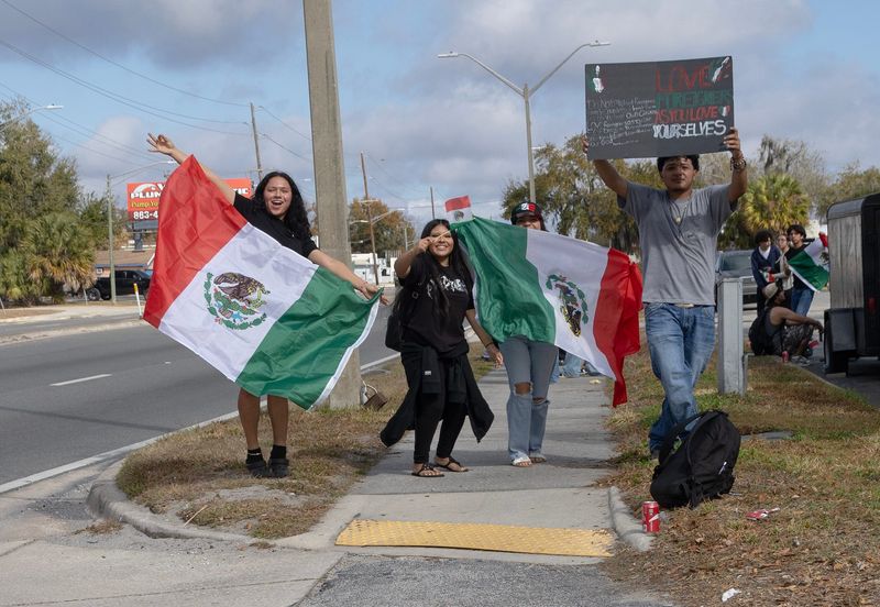 Students from Kathleen High School demonstrate along Wabash Avenue in Lakeland the morning of Feb. 12. Dozens of students walked out of class and left campus to protest the Trump Administration's immigration enforcement policies.