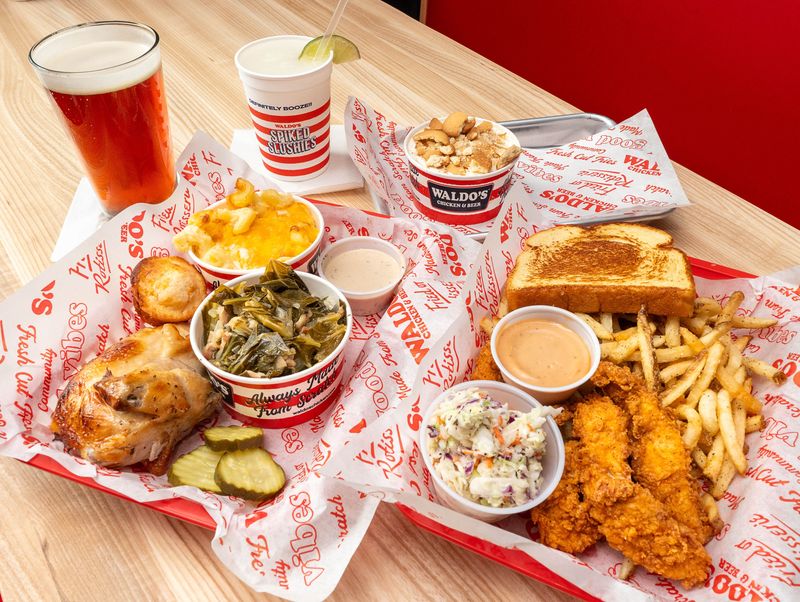 Clockwise from top left, a Pensacola Bay Brewery’s Riptide Amber, a Spiked Slushie Margarita, Banana Pudding, a Tender Box, and a Rotisserie Chicken Plate at the newly opened Waldo's Chicken and Beer on Davis Highway in Pensacola on Feb. 12, 2026.