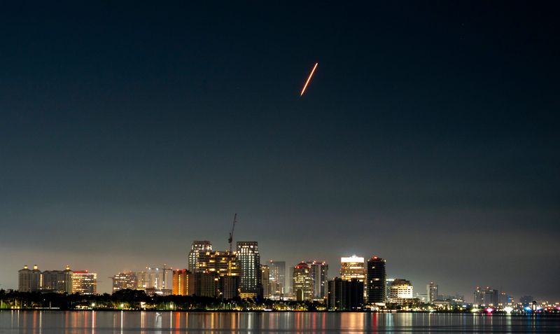 A SpaceX Falcon 9 rocket crosses the West Palm Beach skyline with a Crew Dragon spacecraft from Cape Canaveral Space Force Station.