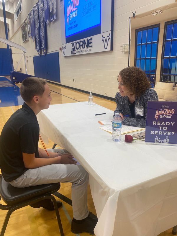 Lakeland Christian School seventh-grader Jenson Walker listens to questions asked by volunteer-parent Sarah Powers of Winter Haven, the CEO of the nonprofit Top Buttons, during The Amazing Shake on Feb. 12, 2026.