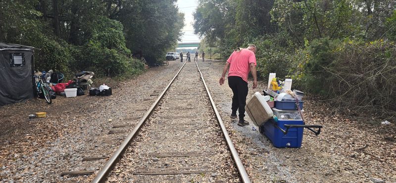 A former U.S. Army veteran, "Jimmy," moves some of his belongings along the railroad tracks in Brownsville where he has been camping for 8 months. The homeless campers were asked to clear out the morning of Feb. 13 to make way for an Alabama & Gulf Coast Railway brush cutter.