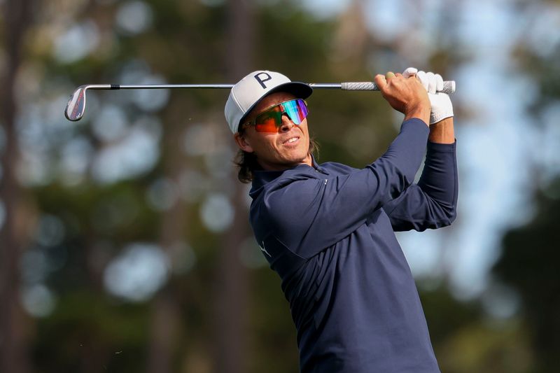 Feb 13, 2026; Pebble Beach, California, USA; Rickie Fowler hits his fairway shot on the 18th hole during the second round of the AT&T Pebble Beach Pro-Am golf tournament at Spyglass Hill Golf Course. Mandatory Credit: Kiyoshi Mio-Imagn Images