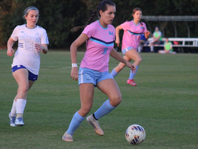 St. Johns Country Day forward Victoria Sarka (9) dribbles away from Mount Dora Christian midfielder Autumn Walker (13) during an FHSAA Region 1-1A high school girls soccer playoff on Feb. 13, 2026. [Clayton Freeman/Florida Times-Union]