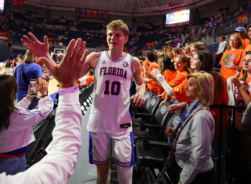 Florida forward Thomas Haugh (10) celebrates with fans after beating Kentucky 92-83 after a NCAA mens basketball game at Steven C. O'Connell Center Exactek arena in Gainesville, FL on Saturday, February 14, 2026. [Alan Youngblood/Gainesville Sun]