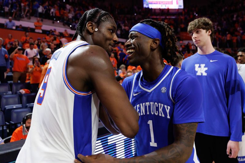 Feb 14, 2026; Gainesville, Florida, USA; Florida Gators center Rueben Chinyelu (9) and Kentucky Wildcats guard Denzel Aberdeen (1) embrace after a game at Exactech Arena at the Stephen C. O'Connell Center. Mandatory Credit: Matt Pendleton-Imagn Images