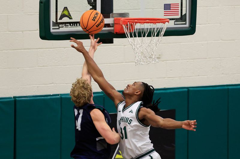 Jacksonville Dolphins guard Jason Thirdkill Jr. (31) fouls North Florida Ospreys forward Dalton Gayman (21) during the second half of an NCAA men’s basketball game at Swisher Gymnasium, Saturday, Feb. 14, 2026, in Jacksonville, Fla. JU held off UNF 63-56. [Corey Perrine/Florida Times-Union]