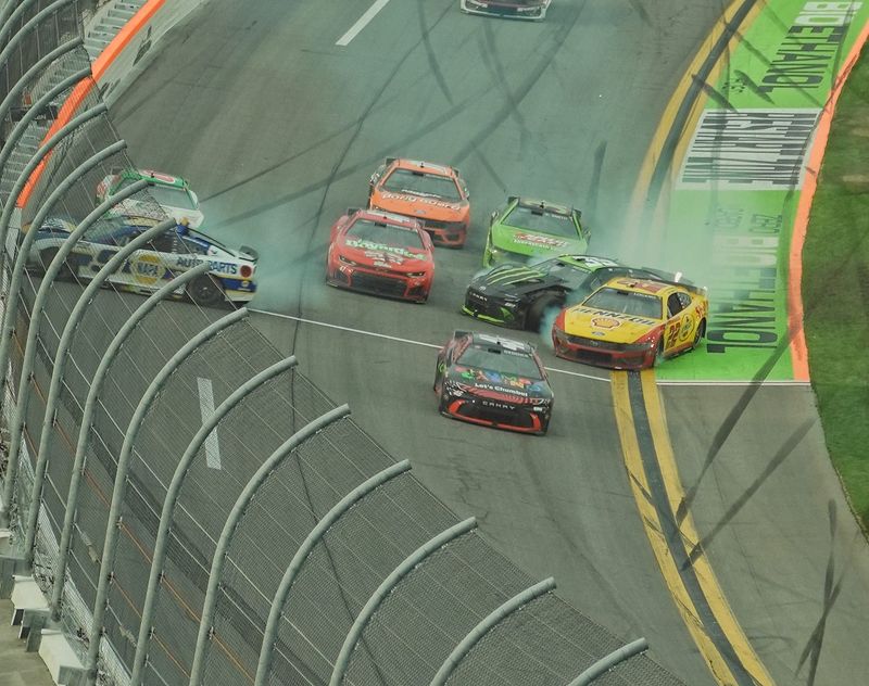 Tyler Reddick (45) sneaks through the final crash involving Joey Logano (22), Chase Elliott (9) and others during the last lap of the Daytona 500, Sunday, Feb. 15, 2026 at Daytona International Speedway.