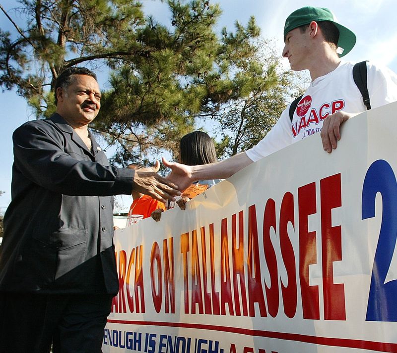 Rev. Jesse Jackson meets John Printy, right, of Tallahassee just before beginning the March on Tallahassee 2004. The march went from Apalachee Parkway to the Capitol building.