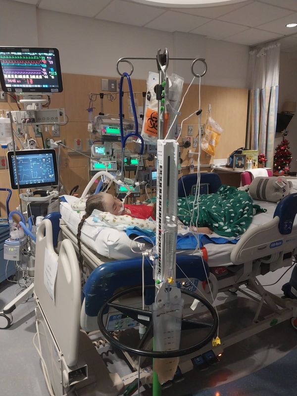 Anwyn Watts, 7, at the hospital during Christmas just days after suffering from a severe brain bleed and undergoing emergency surgery.