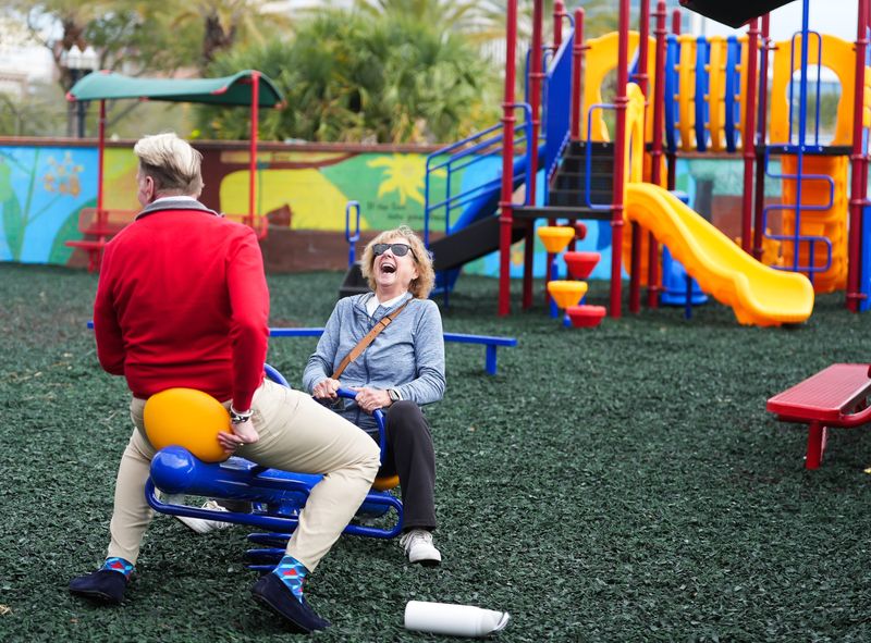 Connie Frank has a laugh while trying out the teeter-totter with Robert Devers, director of development for The Salvation Army, at the newly renovated Hope Park in Jacksonville on Feb. 18, 2026. The 10,000-square-foot playground at The Towers Center of Hope, 900 W. Adams St., was founded in 2015 by Salvation Army supporter Richard Stetina. The playground has been closed since April and has been completely upgraded and modernized to serve the families who are sheltering at the Towers. The renovations cost $80,000, which was paid for by The Warren and Augusta Hume Foundation.