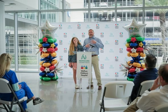 Craig Walker, right, father of cardiology patient Ryleigh Walker, left, 13, talks about her care at Wolfson Children's Hospital and Nemours Children's Health.