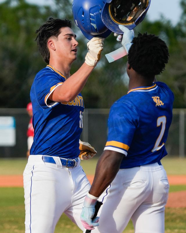 Martin County's Preston Sullivan celebrates his home run with Stone Preston in a high school boys baseball game against Port St. Lucie, Feb. 19, 2026, at Port St. Lucie High School.