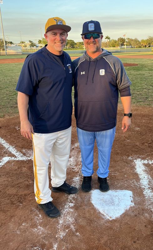 Boca Raton coach Joe Franco, left, and Dr. Joaquin Garcia coach Nick Franco meet at home plate before their Feb. 19 game in Boca Raton. Big brother Nick's team won 11-0.