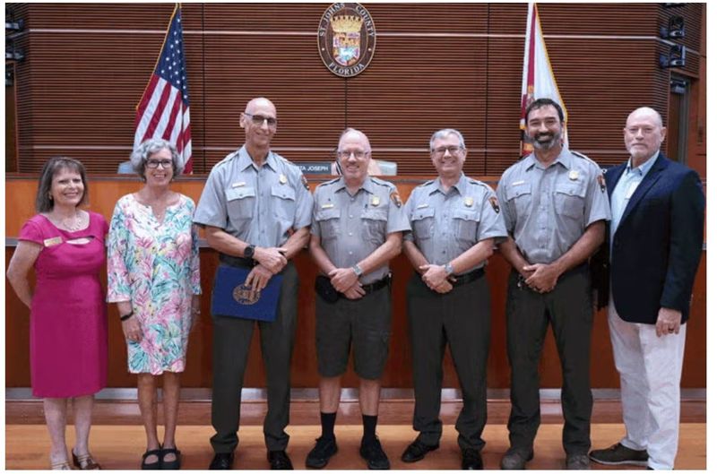 Gordon Wilson receives a certificate of recognition from the St. Johns County Board of County Commissioners upon retiring.