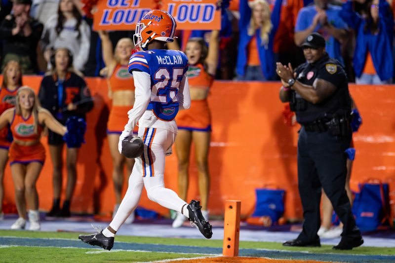 Oct 19, 2024; Gainesville, Florida, USA; Florida Gators defensive back Cormani McClain (25) runs backward into the end zone for a touchdown against the Kentucky Wildcats during the second half at Ben Hill Griffin Stadium. Mandatory Credit: Matt Pendleton-Imagn Images