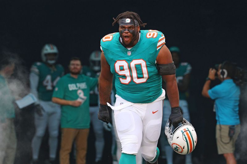 Dec 21, 2025; Miami Gardens, Florida, USA; Miami Dolphins defensive tackle Kenneth Grant (90) enters the field before the game against the Cincinnati Bengals at Hard Rock Stadium. Mandatory Credit: Nathan Ray Seebeck-Imagn Images