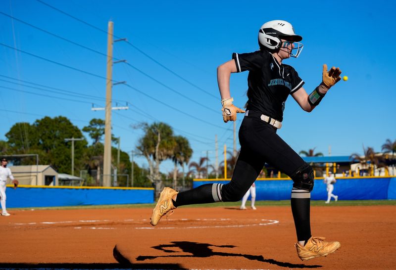 Jensen Beach’s Molly Moore (12) runs to first base during a high school softball game against John Carroll Catholic, Feb. 24, 2026.