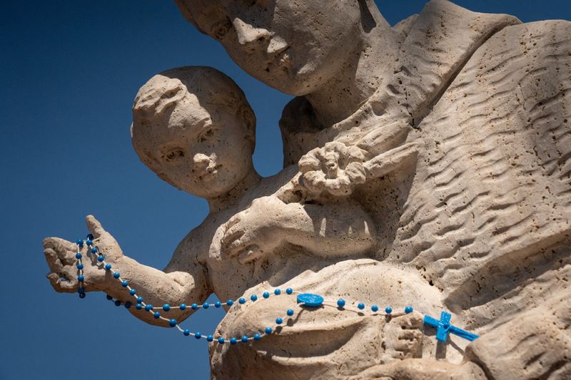 A rosary hangs on a statue at the Diocese of Palm Beach at the Cathedral of St. Ignatius Loyola in Palm Beach Gardens, Fla., on February 24, 2026.