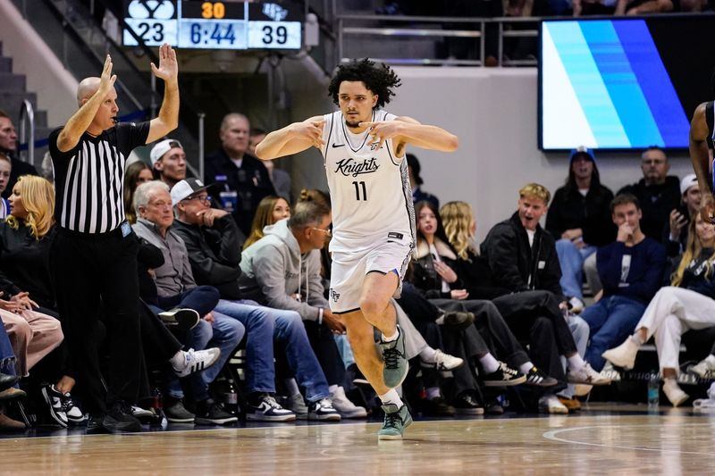 Feb 24, 2026; Provo, Utah, USA; UCF Knights guard Carmelo Pacheco (11) reacts to a made three point shot during the first half against the BYU Cougars at Marriott Center. Mandatory Credit: Aaron Baker-Imagn Images