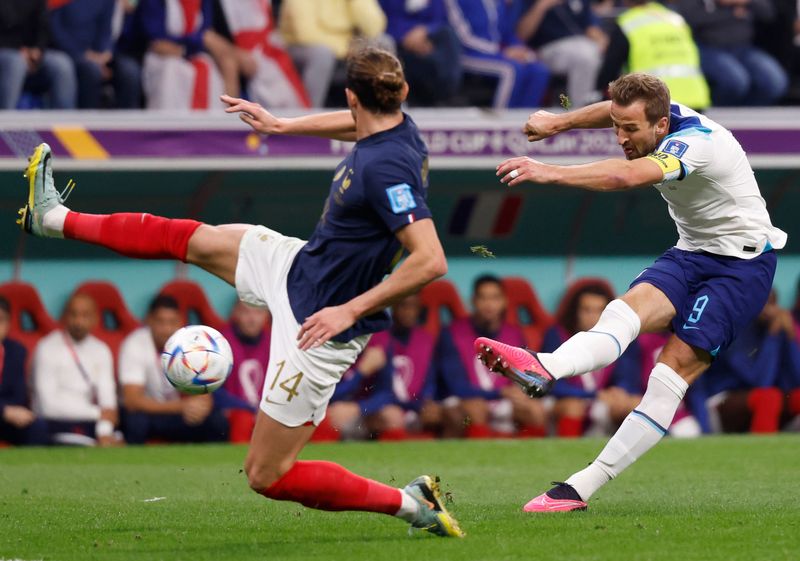 Dec 10, 2022; Al Khor, Qatar; England forward Harry Kane (9) shoots against France midfielder Adrien Rabiot (14) during the first half of a quarterfinal game in the 2022 FIFA World Cup at Al-Bayt Stadium. Mandatory Credit: Yukihito Taguchi-USA TODAY Sports