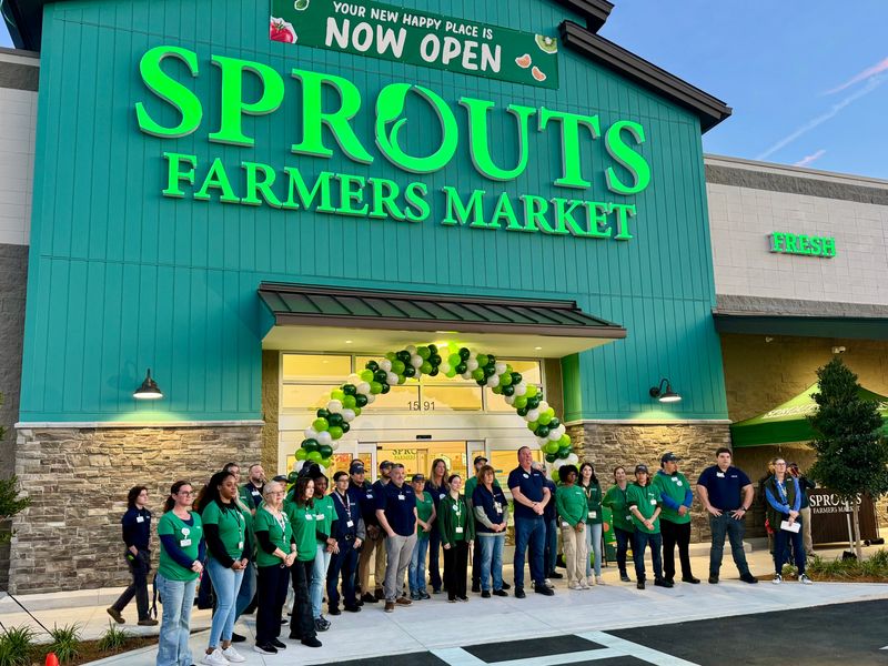 Staff stand outside of Sprouts Farmers Market, preparing for the grand opening of the chain's first Daytona Beach store.