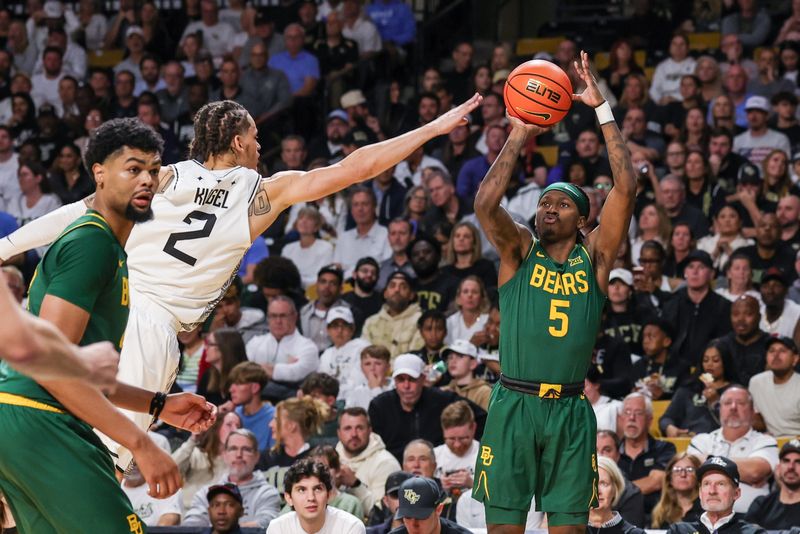 Feb 28, 2026; Orlando, Florida, USA; Baylor Bears guard Obi Agbim (5) shoots against UCF Knights guard Riley Kugel (2) during the second half at Addition Financial Arena. Mandatory Credit: Mike Watters-Imagn Images