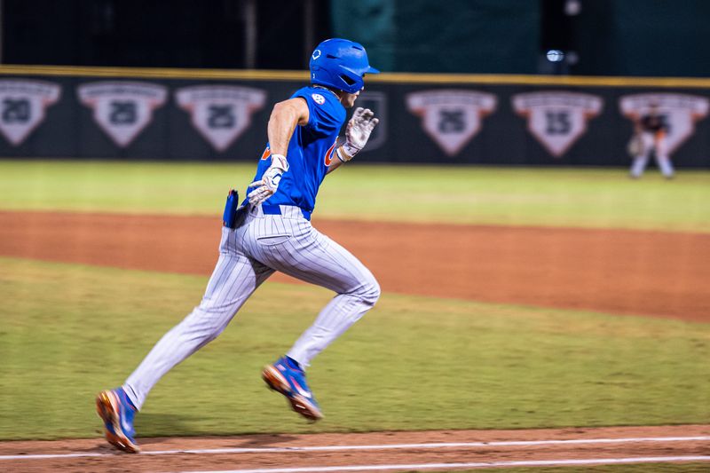 Florida center fielder Kyle Jones running to first base.