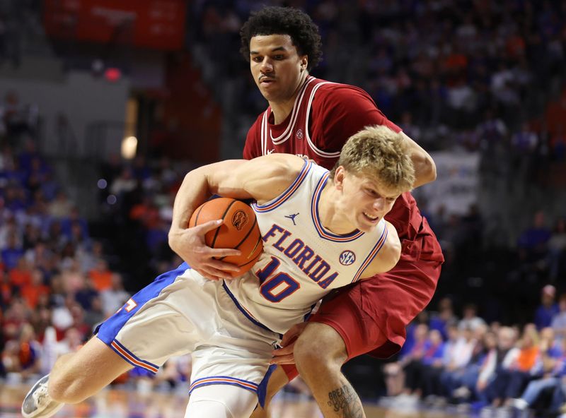 Florida forward Thomas Haugh (10) runs into Arkansas forward Malique Ewin (12) during the second half of an NCAA basketball game at Steven C. O'Connell Center Exactek arena in Gainesville, FL on Saturday, February 28, 2026. [Alan Youngblood/Gainesville Sun]