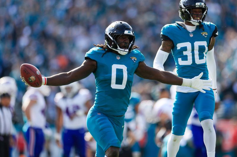 Jacksonville Jaguars linebacker Devin Lloyd (0) celebrates a fumble recovery with cornerback Montaric Brown (30) during the second quarter of an NFL football AFC Wild Card playoff matchup, Sunday, Jan. 11, 2026, in Jacksonville, Fla. [Corey Perrine/Florida Times-Union]