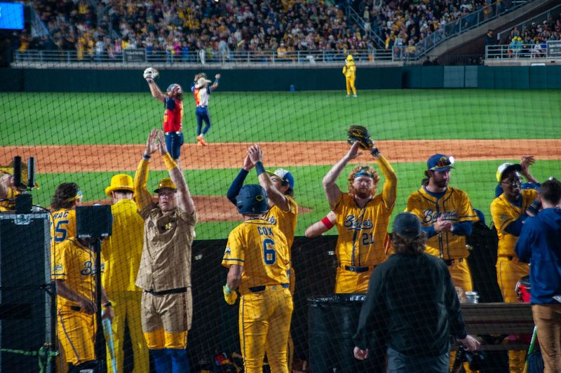 Bringing the spirit: Players from the Savannah Bananas celebrate a key play during their 5-3 victory in Tallahassee. The historic three-day opening weekend at Doak Campbell Stadium officially launched the team's nationwide 50-game regular season.
