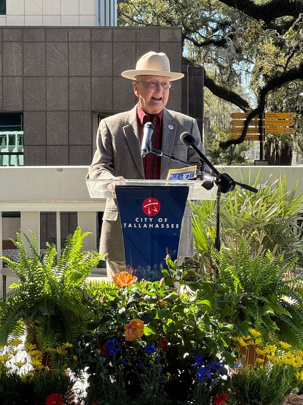 Former Clerk of Courts Dave Lang speaks as he is honored with a road naming, spanning the length of Jefferson Street from South Calhoun to South Monroe, sitting to the side of the county courthouse.
