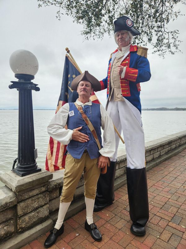 Mike Cross and entertainer Billy Scadlock, as "tall George," dress up in Revolutionary War garb for the Georgefest Grand Parade on Feb. 28, 2026.