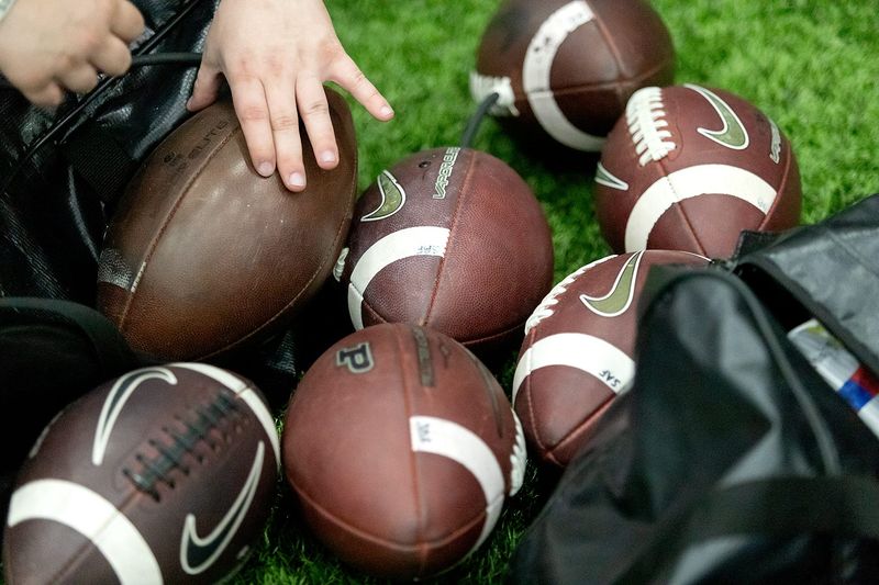Support staff grabs extra footballs to be used in the practice on Tuesday, March 3, 2026, at The Mollenkopf Athletic Center in West Lafayette, Ind. The first practice of the spring training season started at 8:35 a.m.