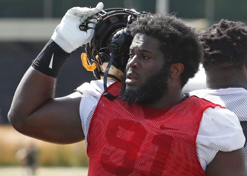 Purdue Boilermakers defensive lineman Cole Brevard (91) takes his helmet off Friday, Aug. 16, 2024, during Purdue football practice at Bimel Outdoor Practice Complex in West Lafayette, Ind.