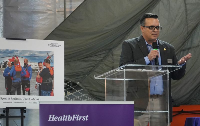 Shane Smith, former U.S. Air Force Reserve 920th Rescue Wing command chief, and co-founder and cfo of Operator Solutions, addresses the audience. Health First and Operator Solutions celebrate formalizing a strategic partnership that ,and will combine hospital emergency trauma and medical expertise with the critical mission skills of Operator Solutions, whose headquarters on Aerospace Drive is where the event was held.