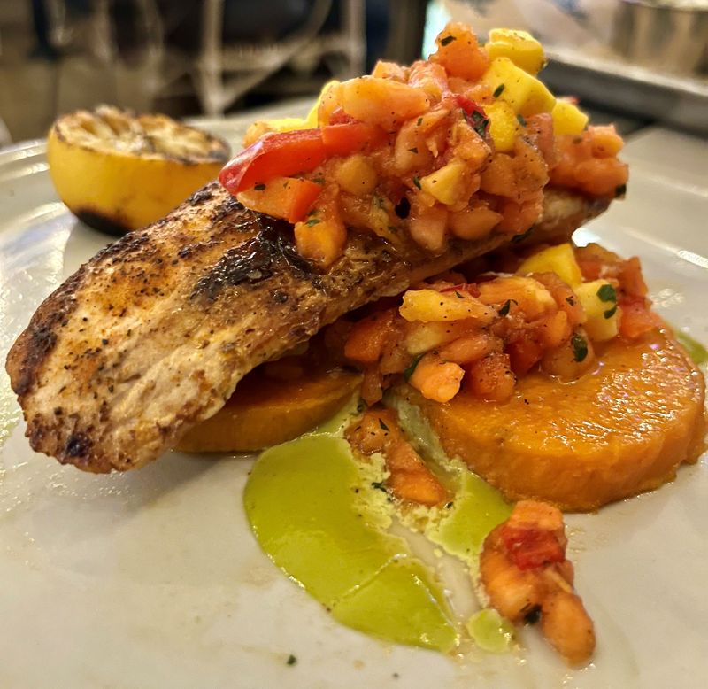 Bimini Basin Seafood & Cocktails' blackened mahi comes with roasted sweet potatoes and a mango papaya salsa.