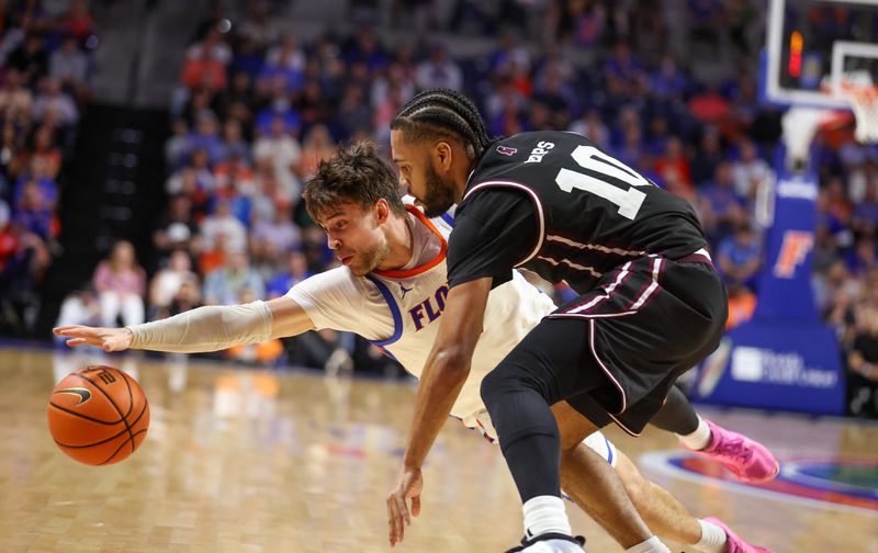 Florida guard Urban Klavzar (7) dives for the loose ball against Mississippi State guard Jayden Epps (10) during the second half of an NCAA mens basketball game at Steven C. O'Connell Center Exactek arena in Gainesville, FL on Tuesday, March 3, 2026. [Alan Youngblood/Gainesville Sun]