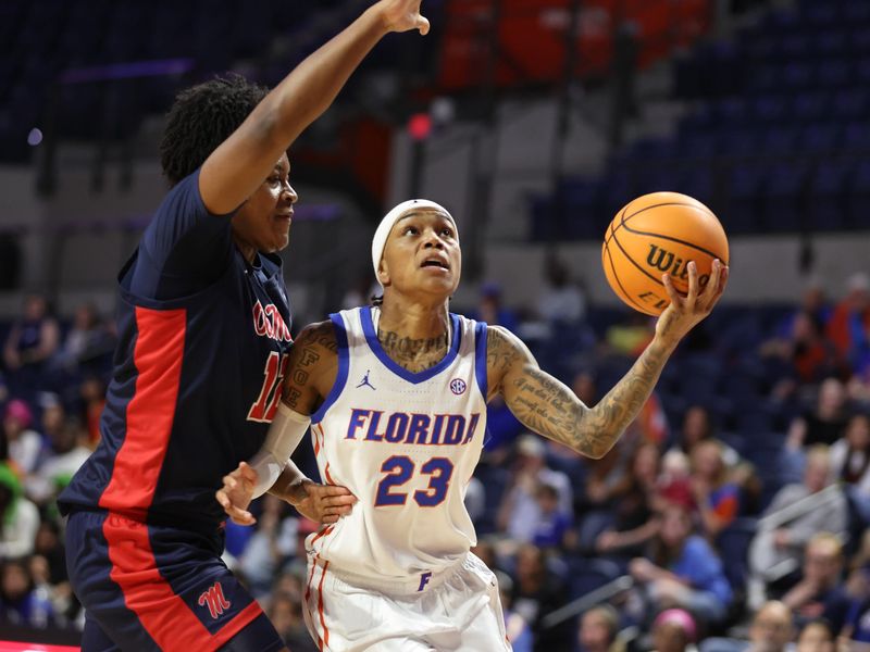 Florida guard Liv McGill (23) shoots past Mississippi forward Christeen Iwuala (12) during the first half of an NCAA womenâ€™s basketball game at Steven C. O'Connell Center Exactek arena in Gainesville, FL on Thursday, February 26, 2026. [Alan Youngblood/Gainesville Sun]
