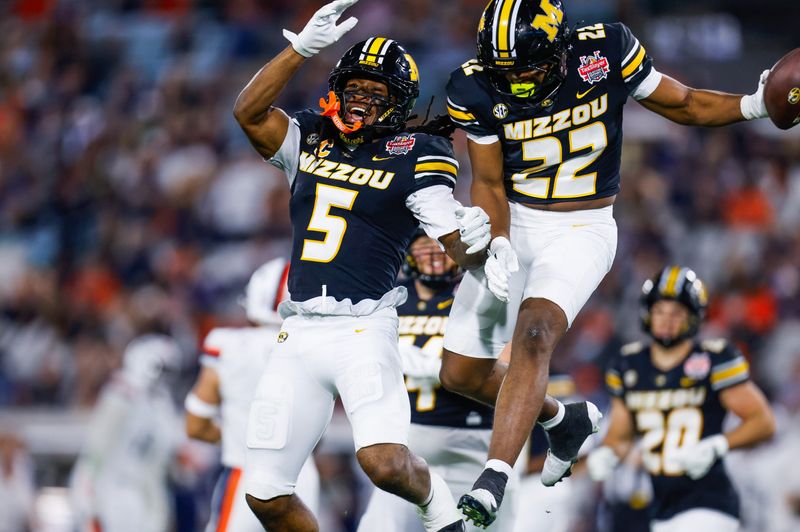 Missouri Tigers linebacker Khalil Jacobs (5) and Missouri Tigers linebacker Dante McClellan (22) celebrate a muffed punt during the second quarter of the TaxSlayer Gator Bowl at EverBank Stadium Saturday December 27, 2025 in Jacksonville, Fla. [Doug Engle/Florida Times-Union]