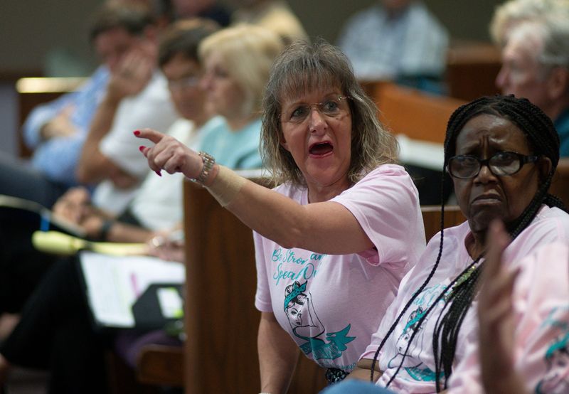 A supporter of Rep. Michelle Salzman gets into a heated exchange of words with Mike Kohler's wife at the close of the Escambia County Board of County Commissioners' public forum on March 5, 2026. Commission Kohler was chastised during the public forum over his recent Facebook comment involving Salzman.