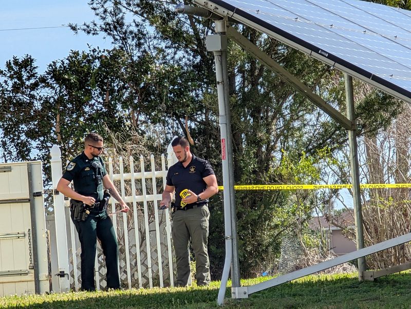 Flagler Sheriff's Department deputies put up crime-scene tape at a home in the 100 block of Florida Park Drive in Palm Coast on Friday, March 6, 2026.