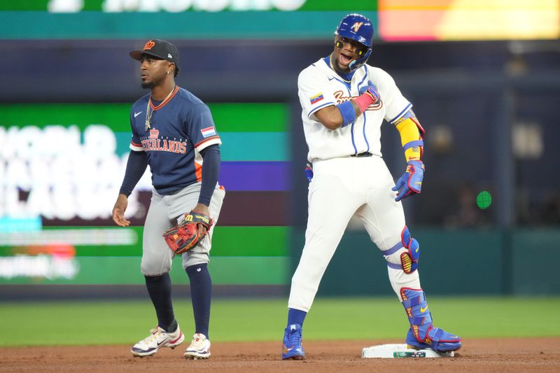 Mar 6, 2026; Miami, FL, United States; Venezuela outfielder Ronald Acuña Jr. (21) celebrates a double in the first inning against the Netherlands at loanDepot Park. Mandatory Credit: Jim Rassol-Imagn Images