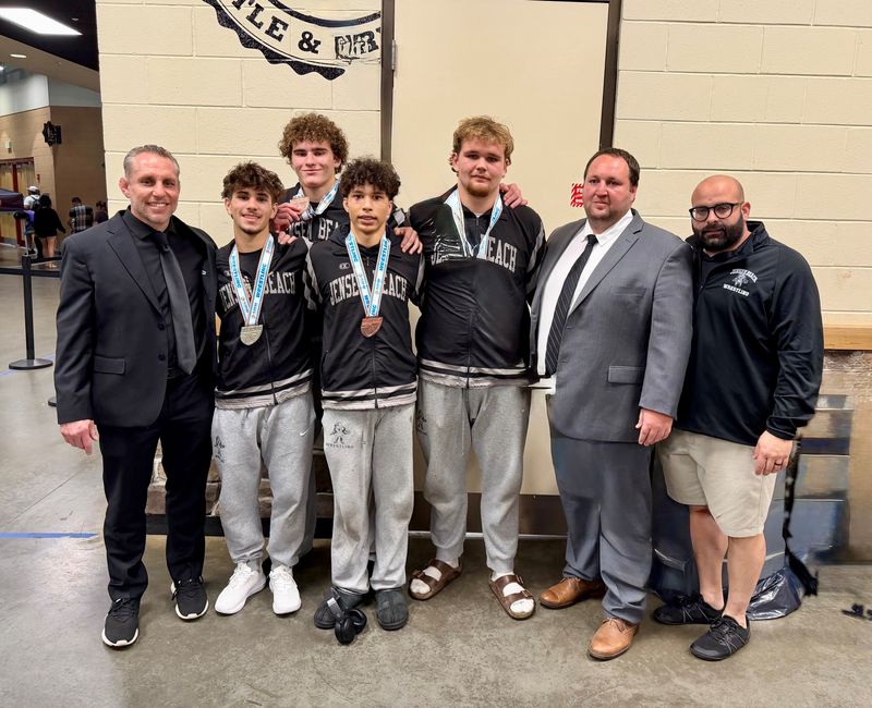 (From L to R): Jensen Beach wrestling head coach Tom McMath, wrestlers Kane Drake, Tyson Reyes, Sair Lopez, Blake Elder and assistants Chris Smith and Anthony Calzadilla poses for photos following the FHSAA state championships on Saturday, March 7, 2025 from Kissimmee.