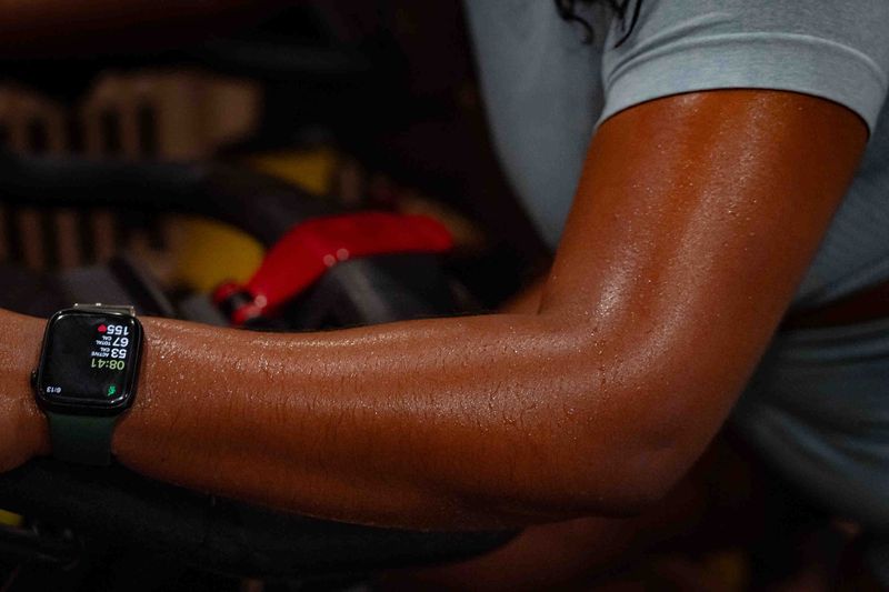 Jade Paul, Boynton Beach, perspires during her stationery bicycle workout during a 15-minute session at HOTWORX in Delray Beach, Fla., on March 5, 2026.