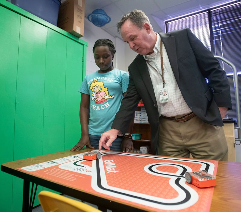 Sherwood Elementary fifth-grader Madyson Harris explains the programming and robotics features to Escambia County Superintendent of Schools Keith Leonard in the school's new STEM lab during its dedication on March 9, 2026. Sherwood is one of two Escambia County schools to receive an FPL grant to build the STEM education labs.