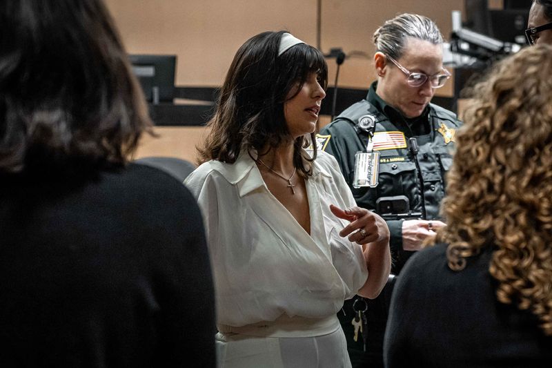 Caroline Schwitzky talks with prosecutors during Cole Preston Goldberg's second-degree attempted murder trial at the Judge Daniel T.K. Hurley Courthouse in downtown West Palm Beach, Fla., on March 10, 2026. Circuit Judge John Parnofiello acquitted Goldberg on March 12.